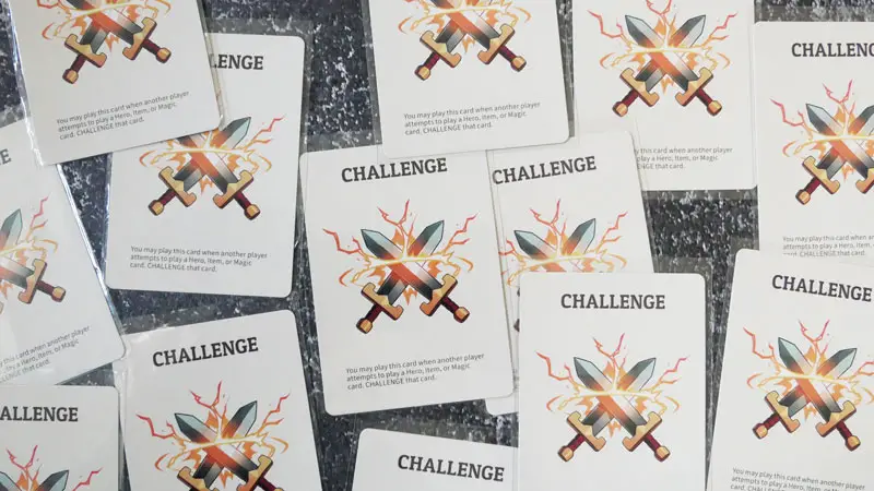 here to slay photo of the challenge cards on a grey background