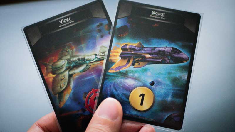 Star Realms 2 Scout and Viper cards held in a human hand