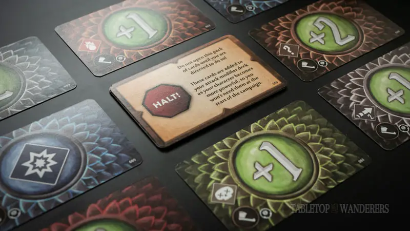 gloomhaven jaws of the lion perks hatchet cards on a dark surface